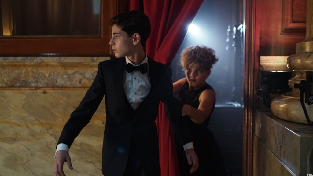 Selena helps Bruce find an escape route, but he won't leave Alfred behind.